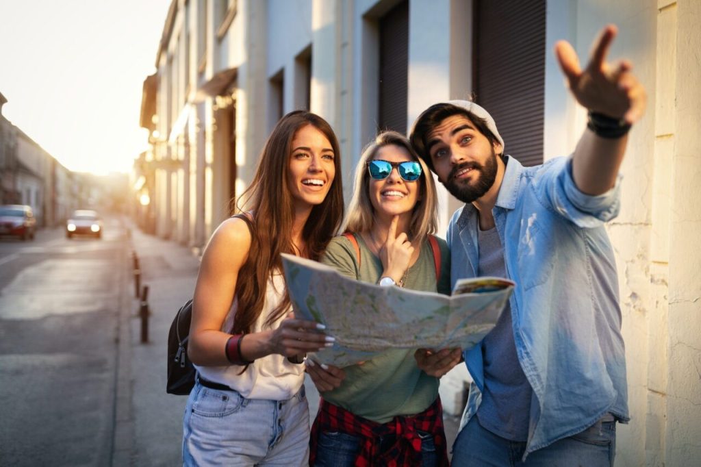Happy friends enjoying sightseeing tour in the city